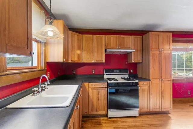 a view of a room that has a window and a shower curtain