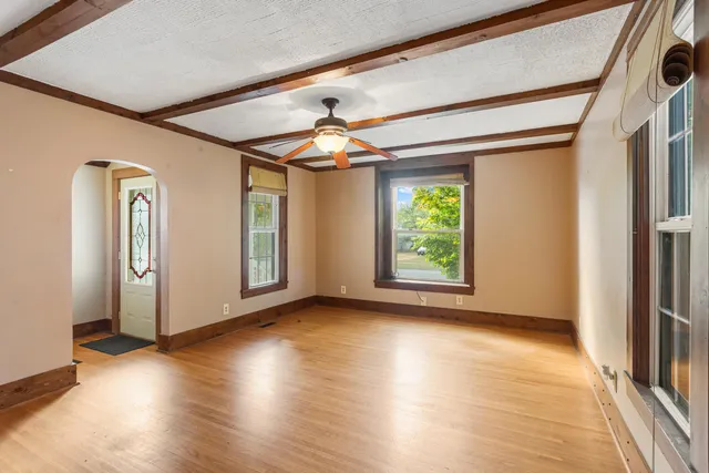 wooden floor in an empty room with a window