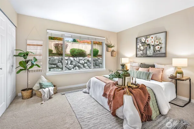 a bed sitting in a bedroom next to a window