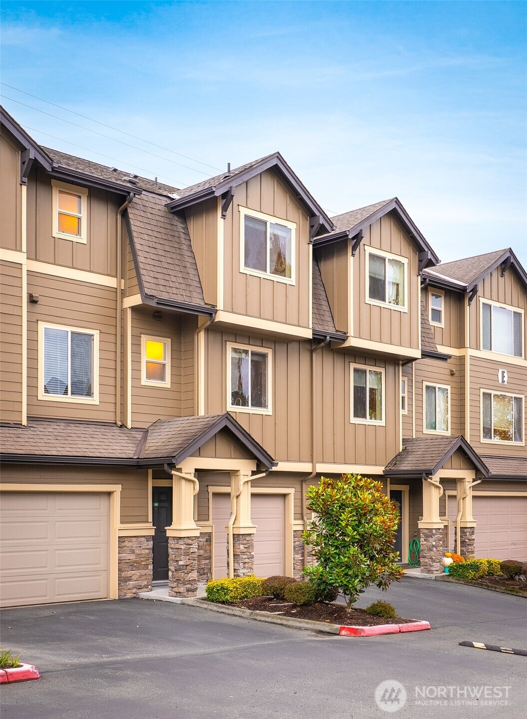 1900 Weaver Road, Unit E102 Snohomish, WA 98290 - Photo 17 of 19 a view of a white house with large windows and a small yard