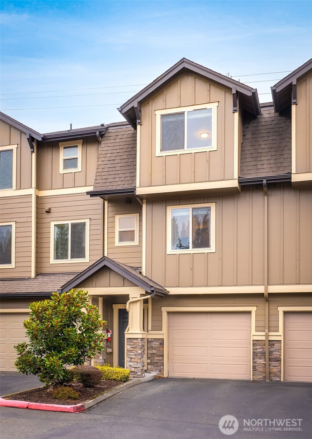 1900 Weaver Road, Unit E102 Snohomish, WA 98290 - Photo 2 of 19 a front view of a house with a yard and garage