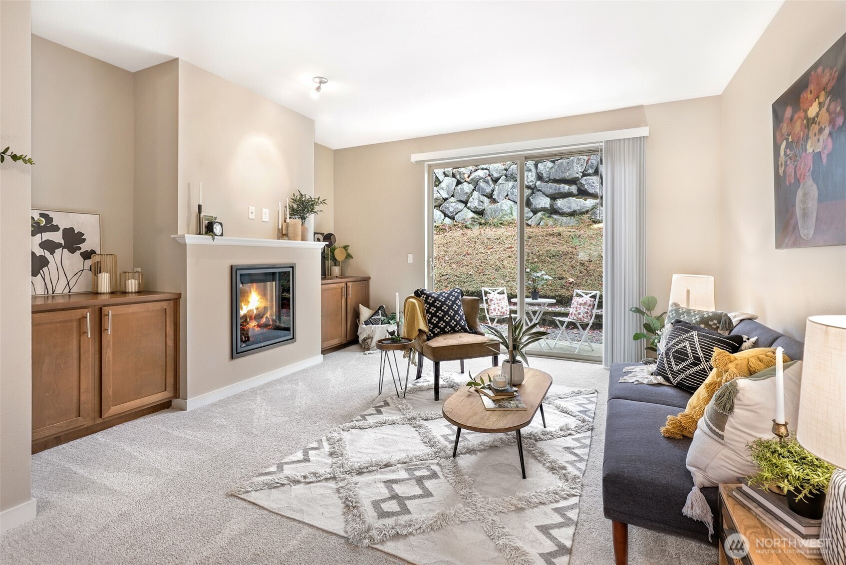 1900 Weaver Road, Unit E102 Snohomish, WA 98290 - Photo 3 of 19 a living room with furniture a fireplace and a floor to ceiling window