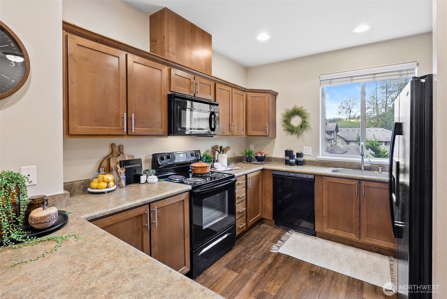 1900 Weaver Road, Unit E102 Snohomish, WA 98290 - Photo 9 of 19 a kitchen with stainless steel appliances granite countertop a stove a sink and a microwave