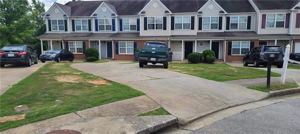 a front view of a residential apartment building with a yard