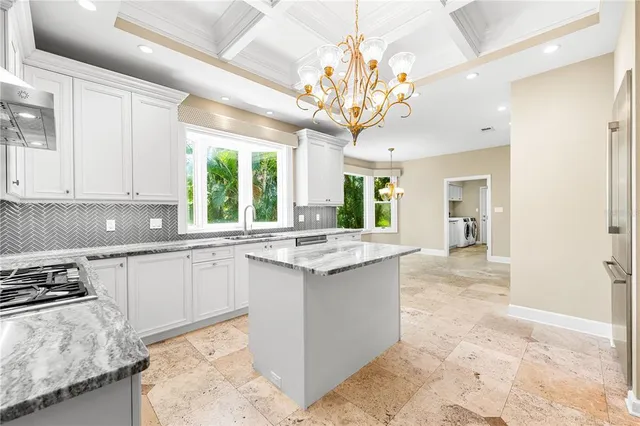 a kitchen with stainless steel appliances granite countertop a stove oven and a refrigerator