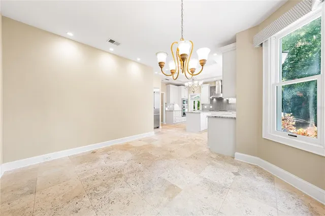 an empty room with windows and a ceiling fan