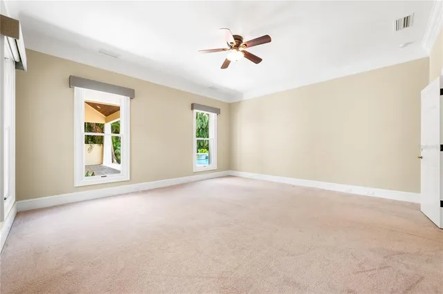 a view of house with a yard and potted plants