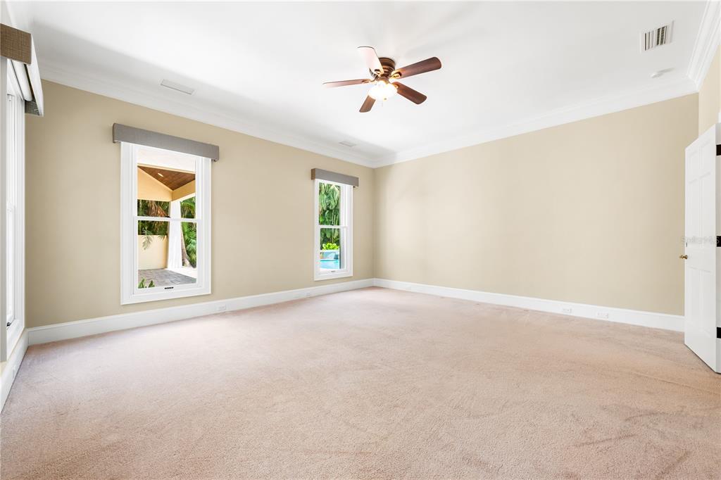 133 Osprey Point Drive Osprey, FL 34229 - Photo 36 of 99 an empty room with windows and ceiling fan