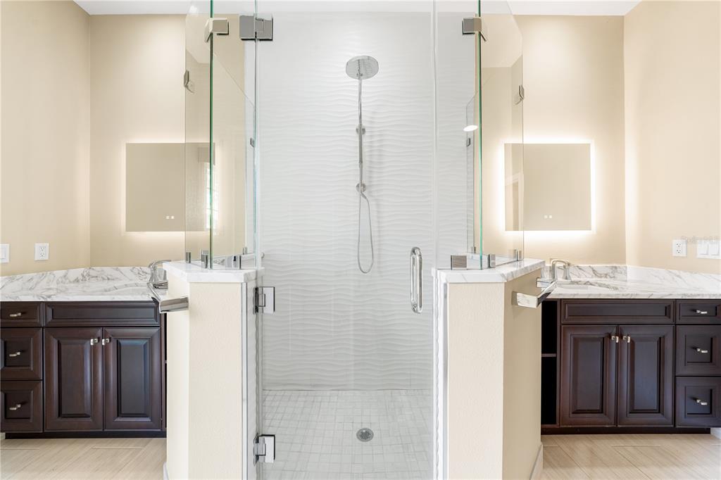 133 Osprey Point Drive Osprey, FL 34229 - Photo 39 of 99 a bathroom with a granite countertop sink a mirror and a shower