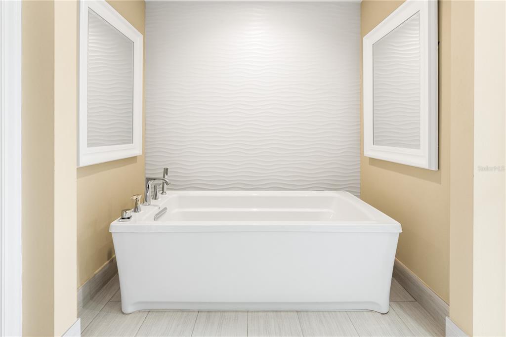 133 Osprey Point Drive Osprey, FL 34229 - Photo 41 of 99 a white bath tub sitting in a bathroom