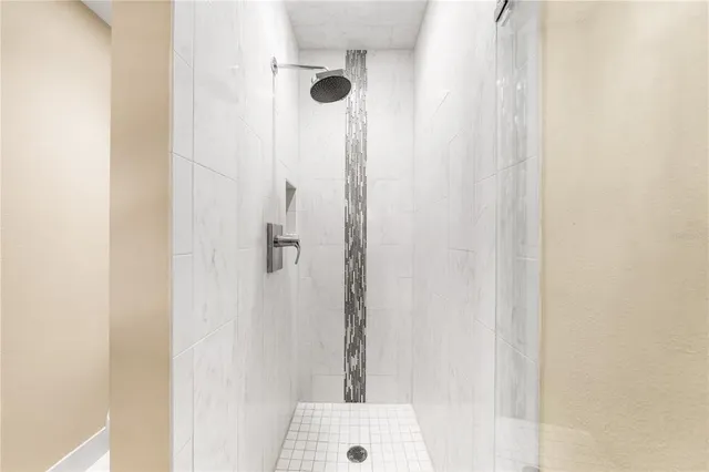 an aerial view of residential houses with outdoor space and trees