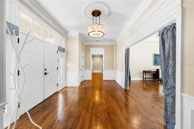 a bedroom with bed tv and a window