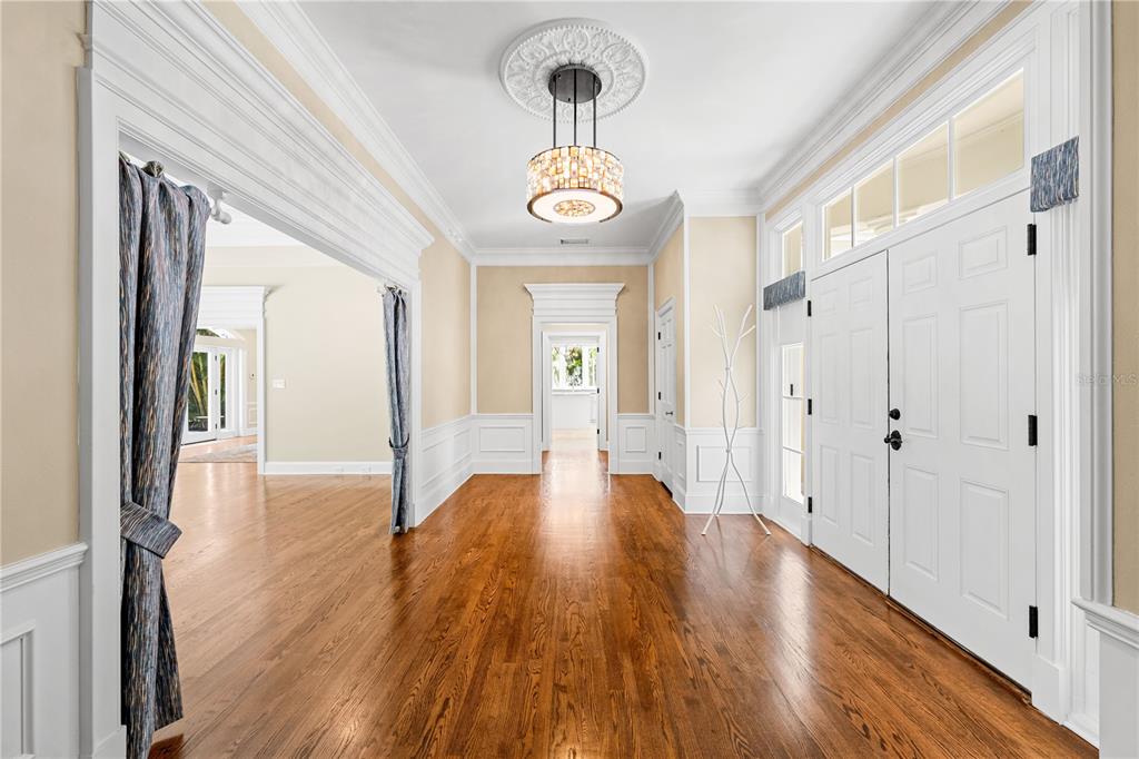 133 Osprey Point Drive Osprey, FL 34229 - Photo 7 of 99 a view of a hallway with wooden floor and a door