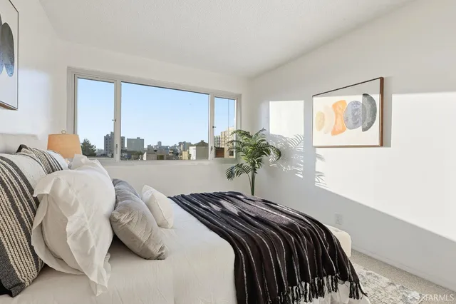 a bed sitting in a bedroom next to a window
