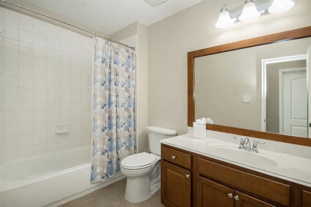 9754 Boyton Canyon Road Frisco, TX 75035 - Photo 17 of 21 a bathroom with a sink a toilet and shower