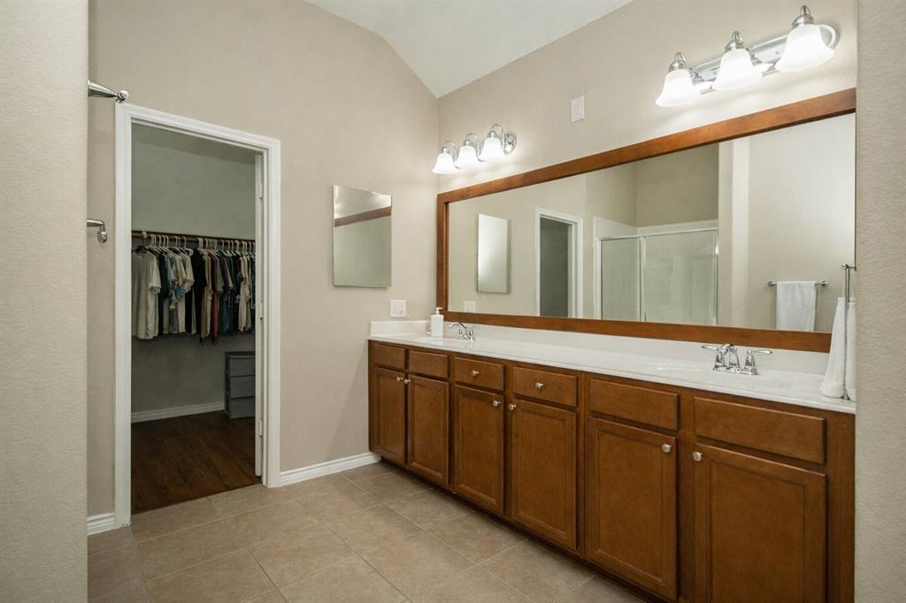 9754 Boyton Canyon Road Frisco, TX 75035 - Photo 5 of 21 a spacious bathroom with a double vanity sink and a mirror