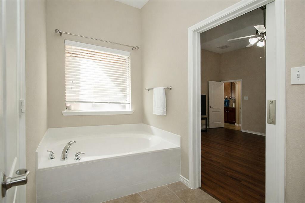 9754 Boyton Canyon Road Frisco, TX 75035 - Photo 6 of 21 a bathroom with a bathtub and a shower