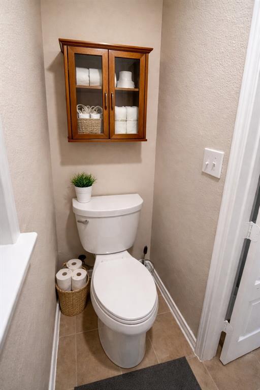 9754 Boyton Canyon Road Frisco, TX 75035 - Photo 7 of 21 a white toilet sitting next to a bathroom sink