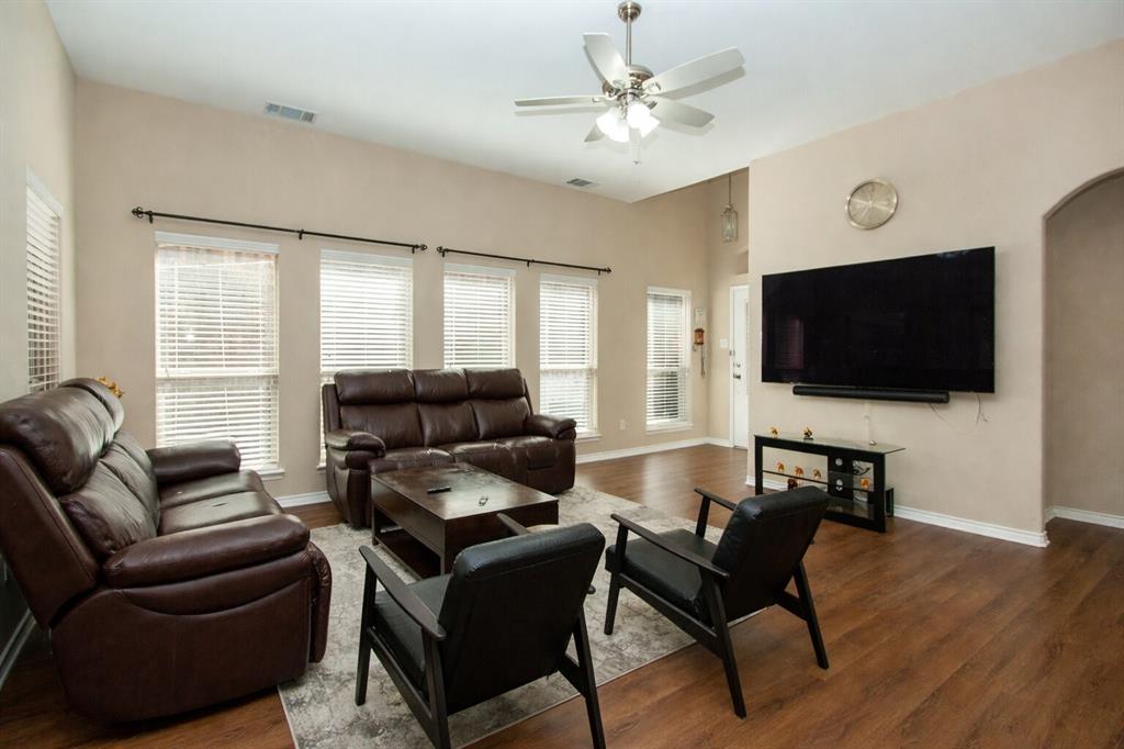 9754 Boyton Canyon Road Frisco, TX 75035 - Photo 8 of 21 a living room with furniture and a flat screen tv