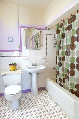 a bathroom with a sink toilet and mirror