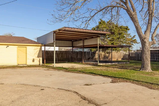 a backyard of a house with a basket ball court and outdoor seating