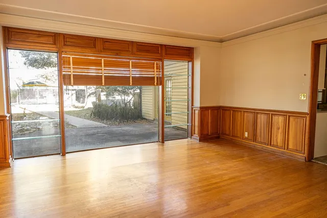 a view of an empty room with glass door