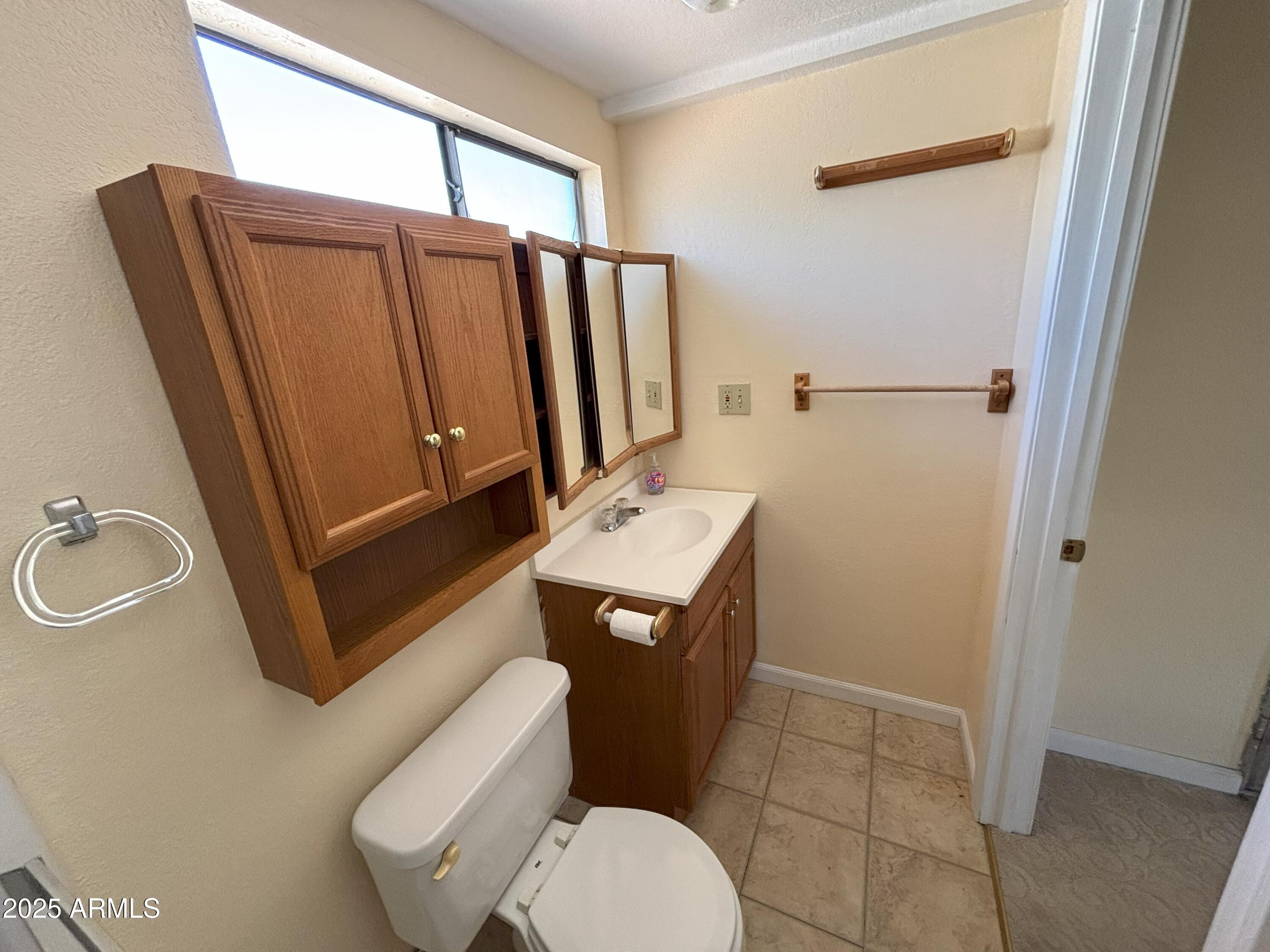 17200 West Bell Road, Unit 2195 Surprise, AZ 85374 - Photo 12 of 16 a bathroom with a sink toilet and shower