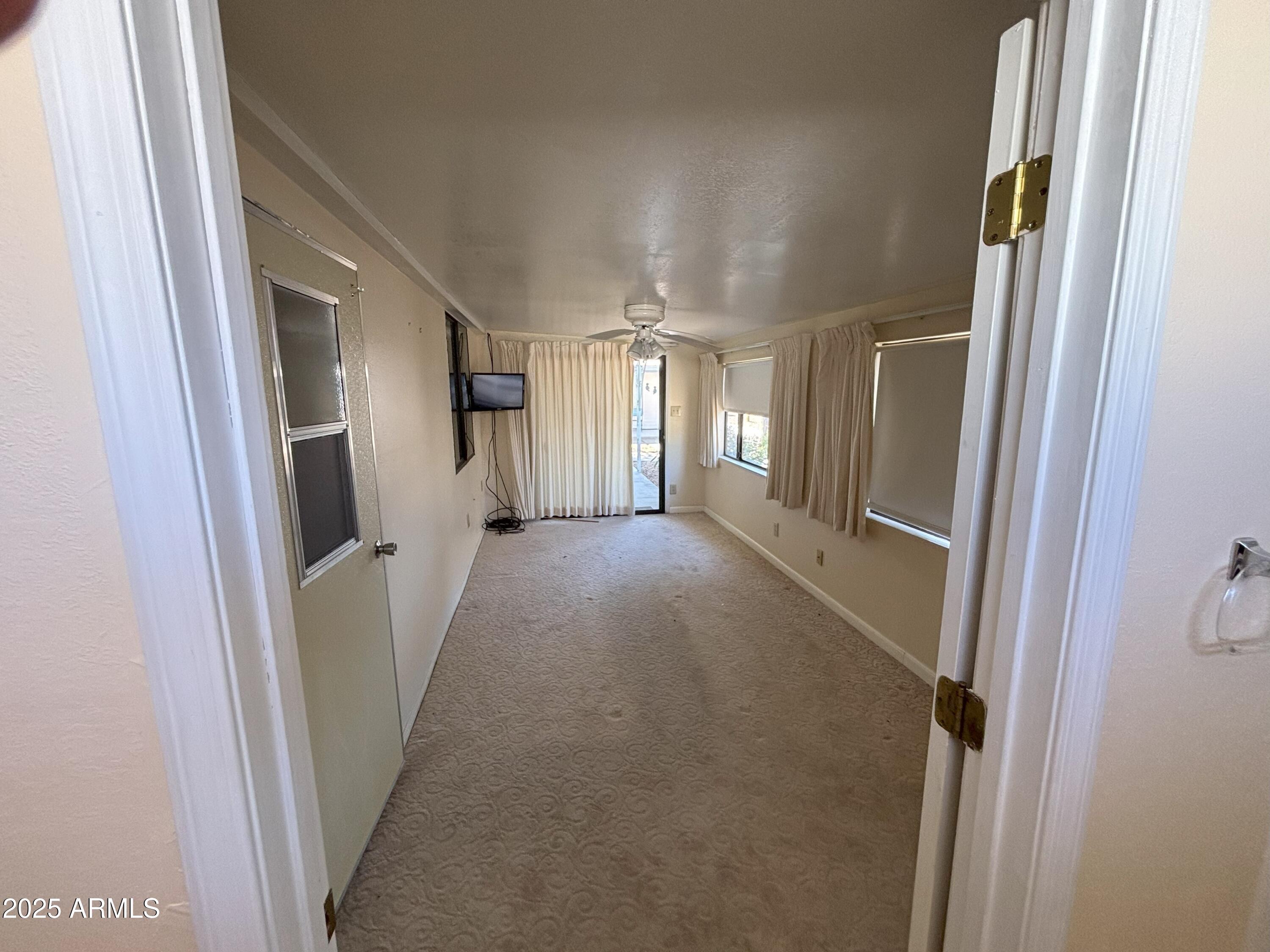 17200 West Bell Road, Unit 2195 Surprise, AZ 85374 - Photo 13 of 16 a view of a hallway with wooden floor and staircase
