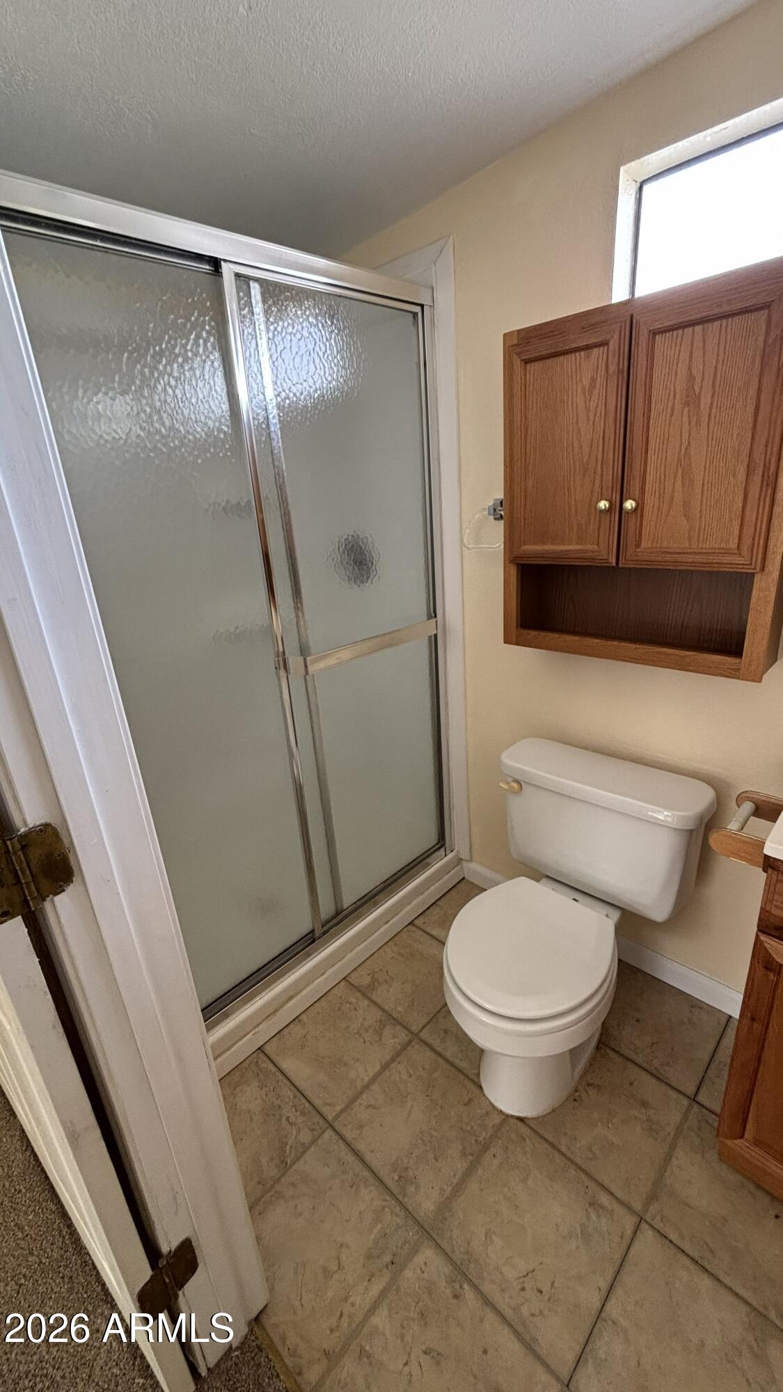 17200 West Bell Road, Unit 2195 Surprise, AZ 85374 - Photo 18 of 27 a bathroom with a toilet and a shower
