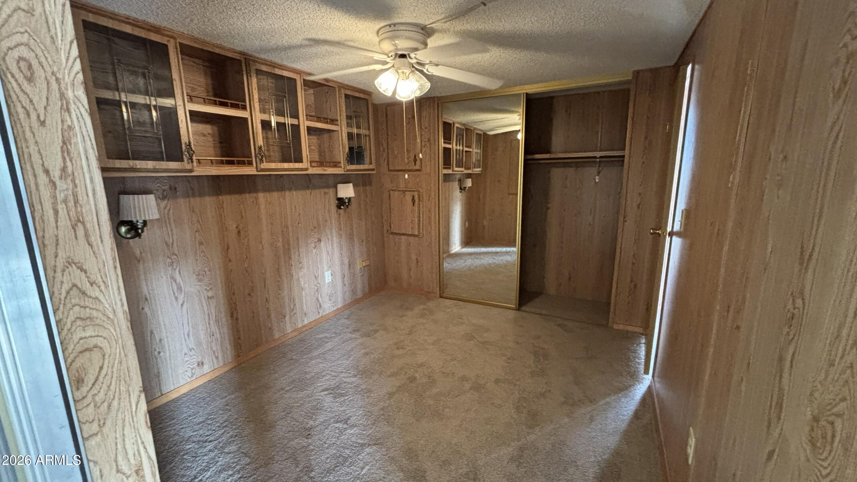 17200 West Bell Road, Unit 2195 Surprise, AZ 85374 - Photo 21 of 27 a view of a hallway with wooden shelves