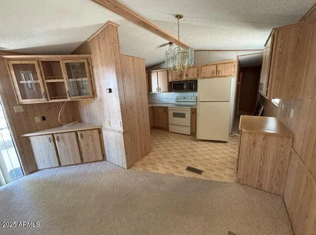 a view of kitchen with refrigerator and microwave