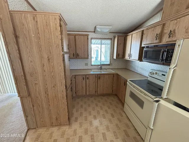 a kitchen with stainless steel appliances a refrigerator and a sink
