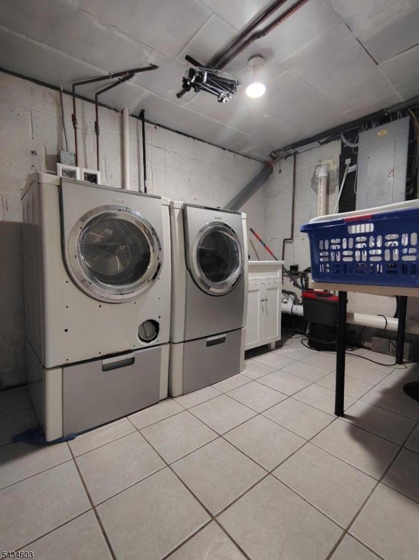 442 River Road North Arlington, NJ 07031 - Photo 24 of 26 a utility room with dryer washer and a view of living room