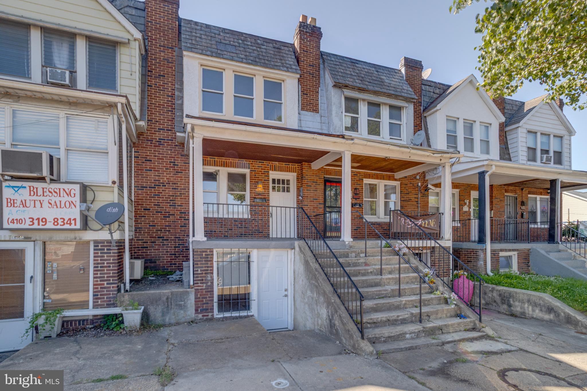 5878 Belair Road Baltimore, MD 21206 - Photo 1 of 41 a front view of a residential apartment building with a yard