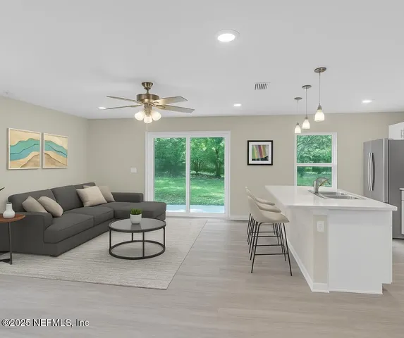 a living room with furniture and a large window