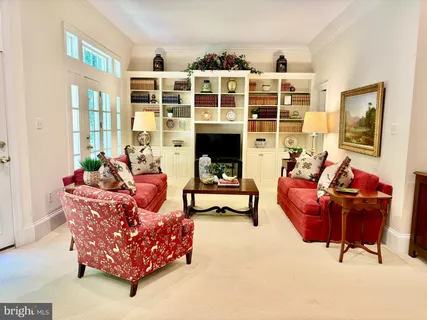 a living room with furniture and large windows