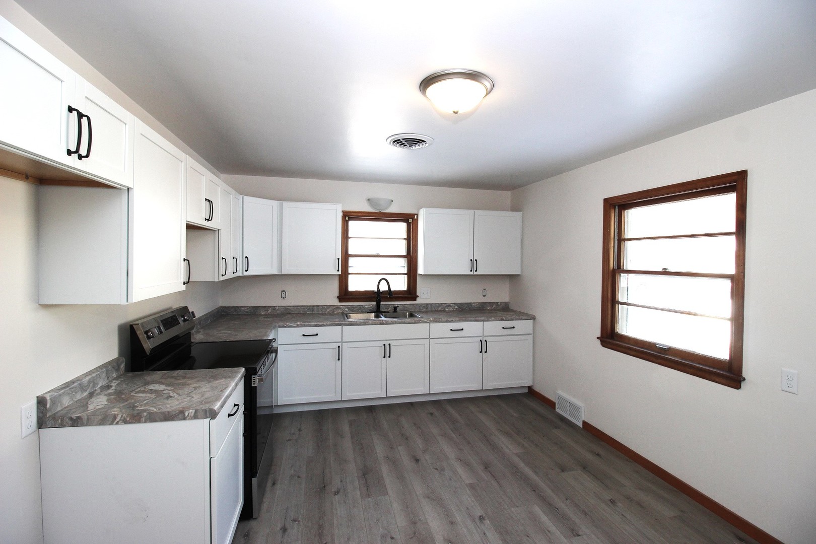 108 East Gridley Road Gridley, IL 61744 - Photo 15 of 22 a kitchen with a sink stove and cabinets
