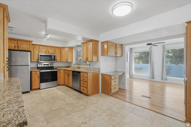 392 Perrine Drive Midvale, UT 84047 - Photo 7 of 37 Kitchen opens to sun room/dining room
