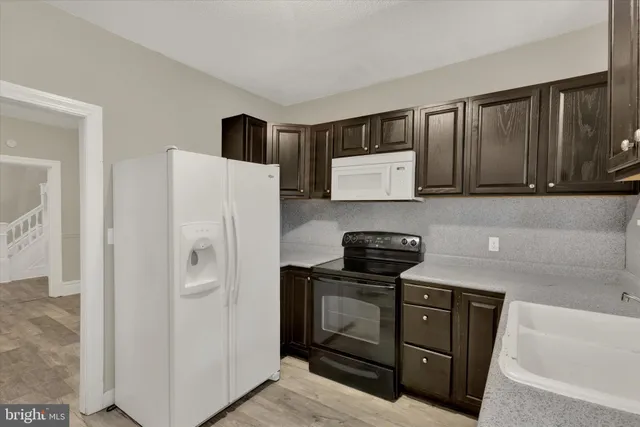 a kitchen with stainless steel appliances a stove a microwave and a refrigerator