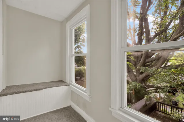 a bathroom with a sink a toilet and a window