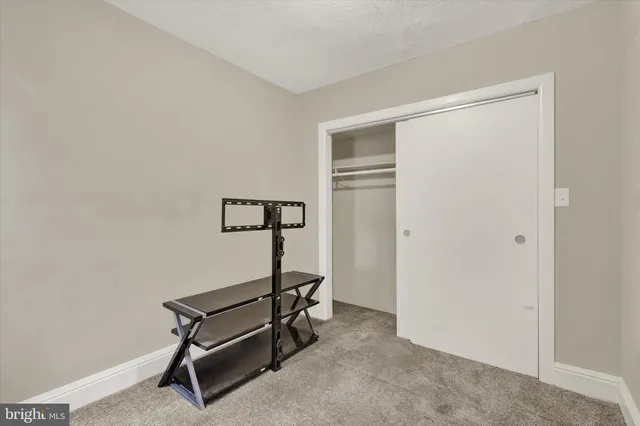 a view of a livingroom with workspace and a couch