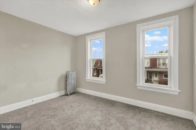 a bedroom with bed and a potted plant