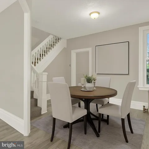a view of a room with furniture and wooden floor