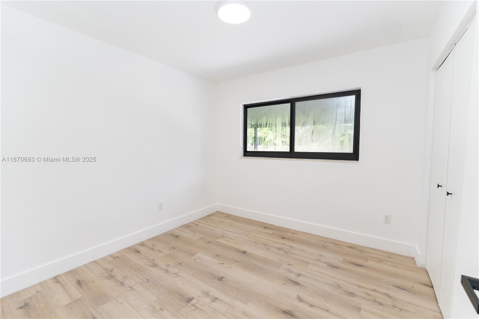 10441 Southwest 50th Terrace Miami, FL 33165 - Photo 11 of 19 an empty room with a window