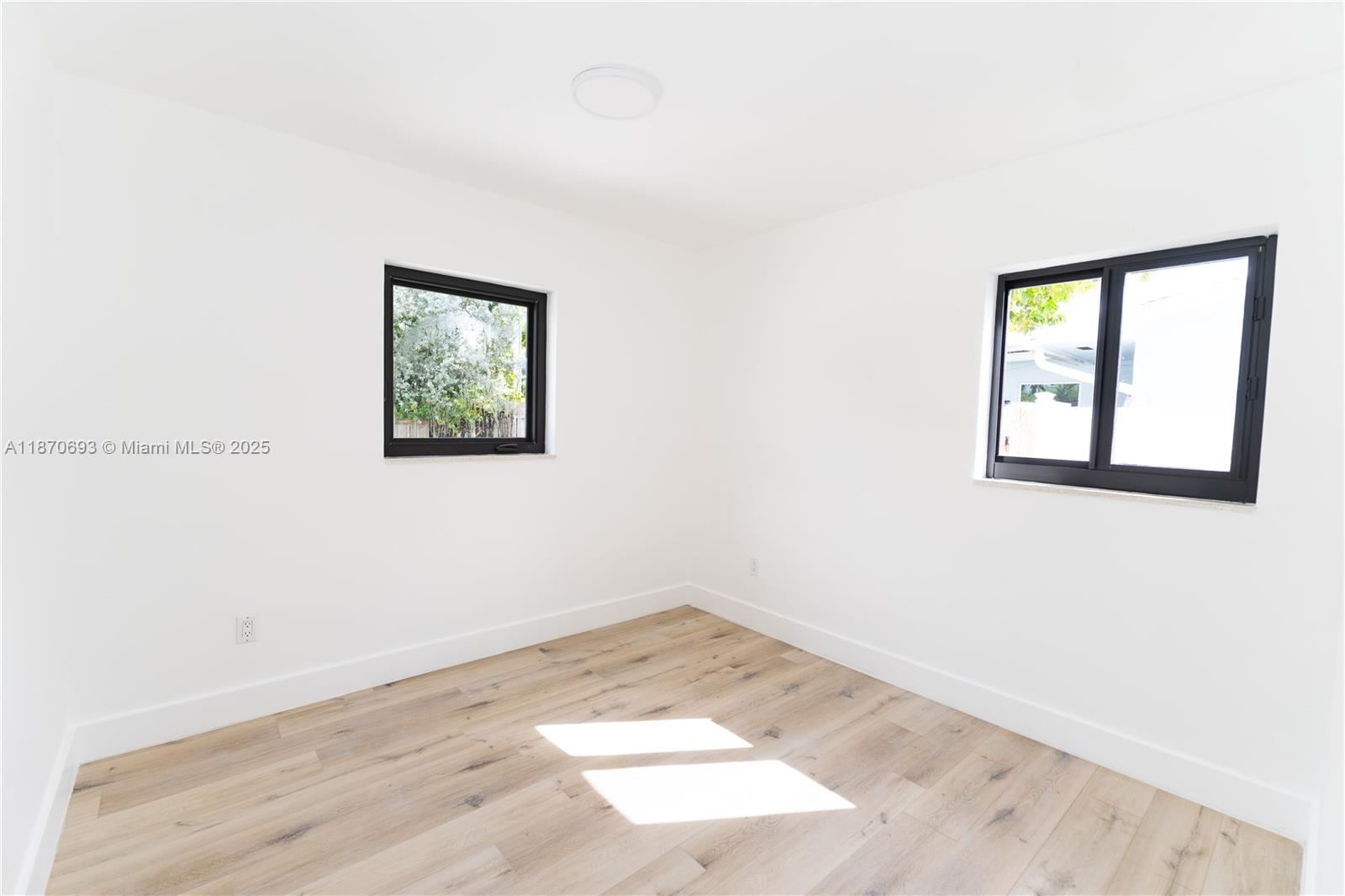10441 Southwest 50th Terrace Miami, FL 33165 - Photo 13 of 19 an empty room with wooden floor and windows