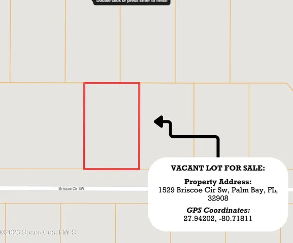 a brick building with a big yard and large trees