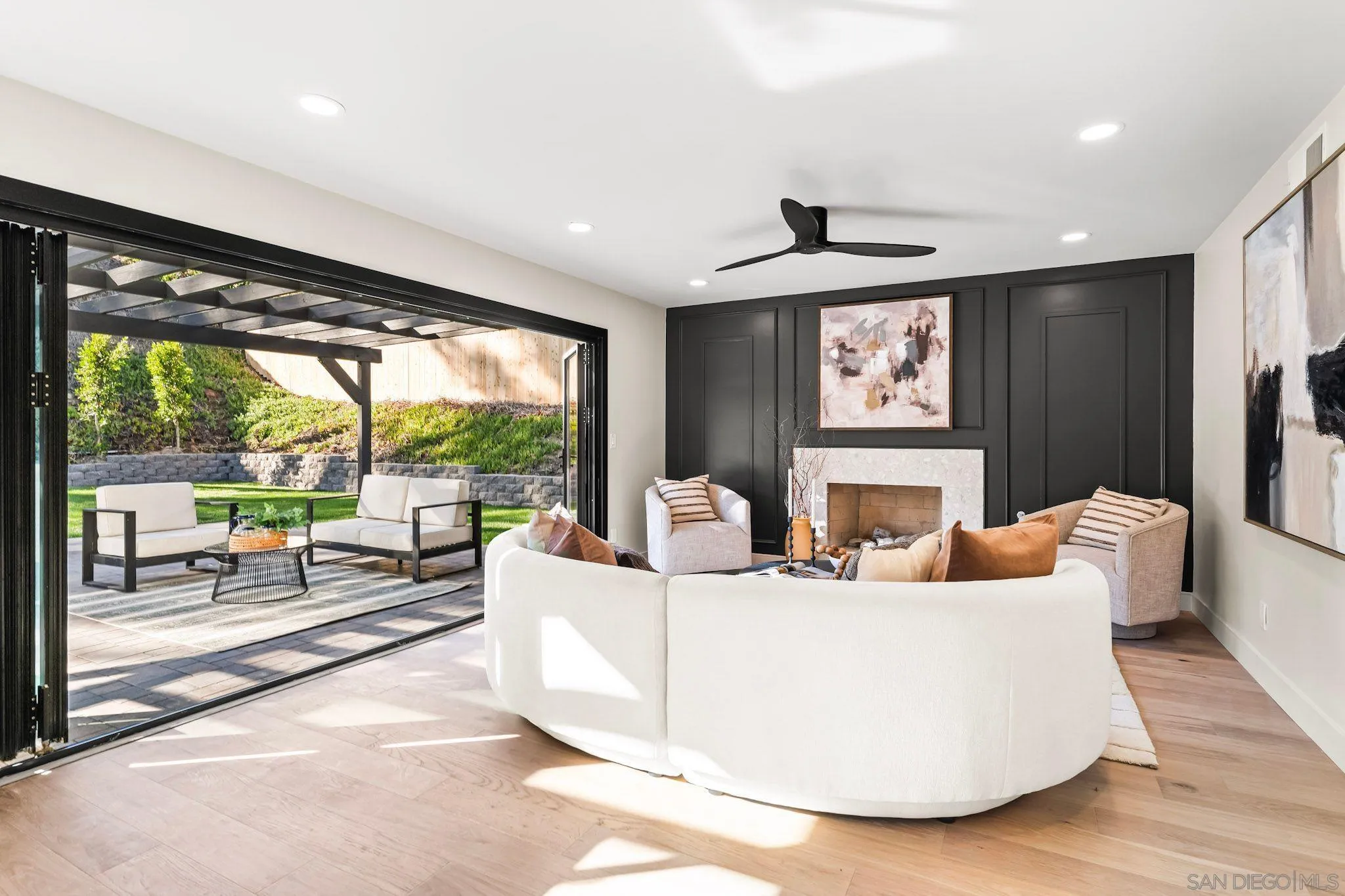 13334 Barbados Way Del Mar, CA 92014 - Photo 7 of 31 a living room with fireplace furniture and a large window