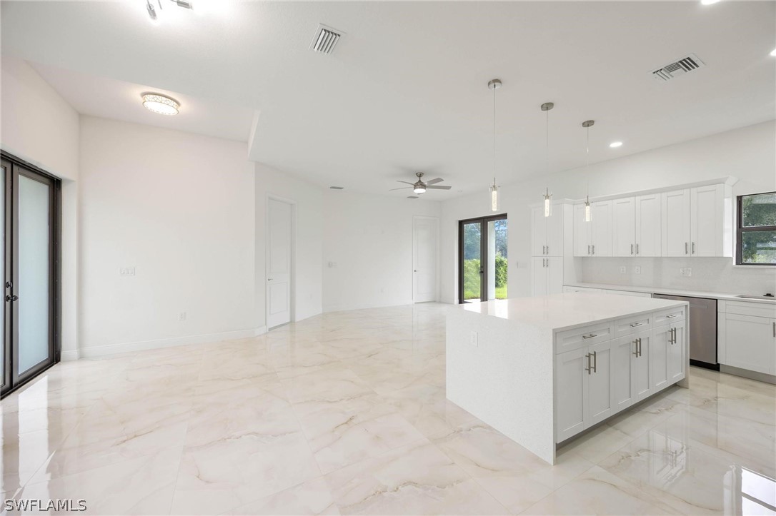 2909 37th Street Southwest Lehigh Acres, FL 33976 - Photo 11 of 29 a view of a kitchen with white cabinets