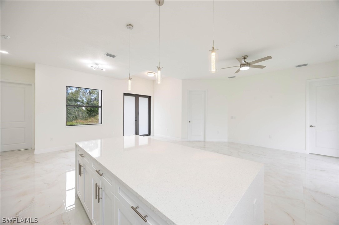 2909 37th Street Southwest Lehigh Acres, FL 33976 - Photo 13 of 29 an empty room with fan and a ceiling fan