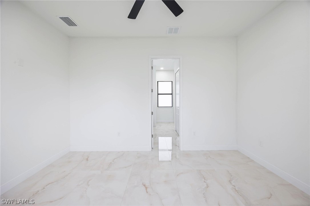 2909 37th Street Southwest Lehigh Acres, FL 33976 - Photo 17 of 29 an empty room with closet and chandelier fan